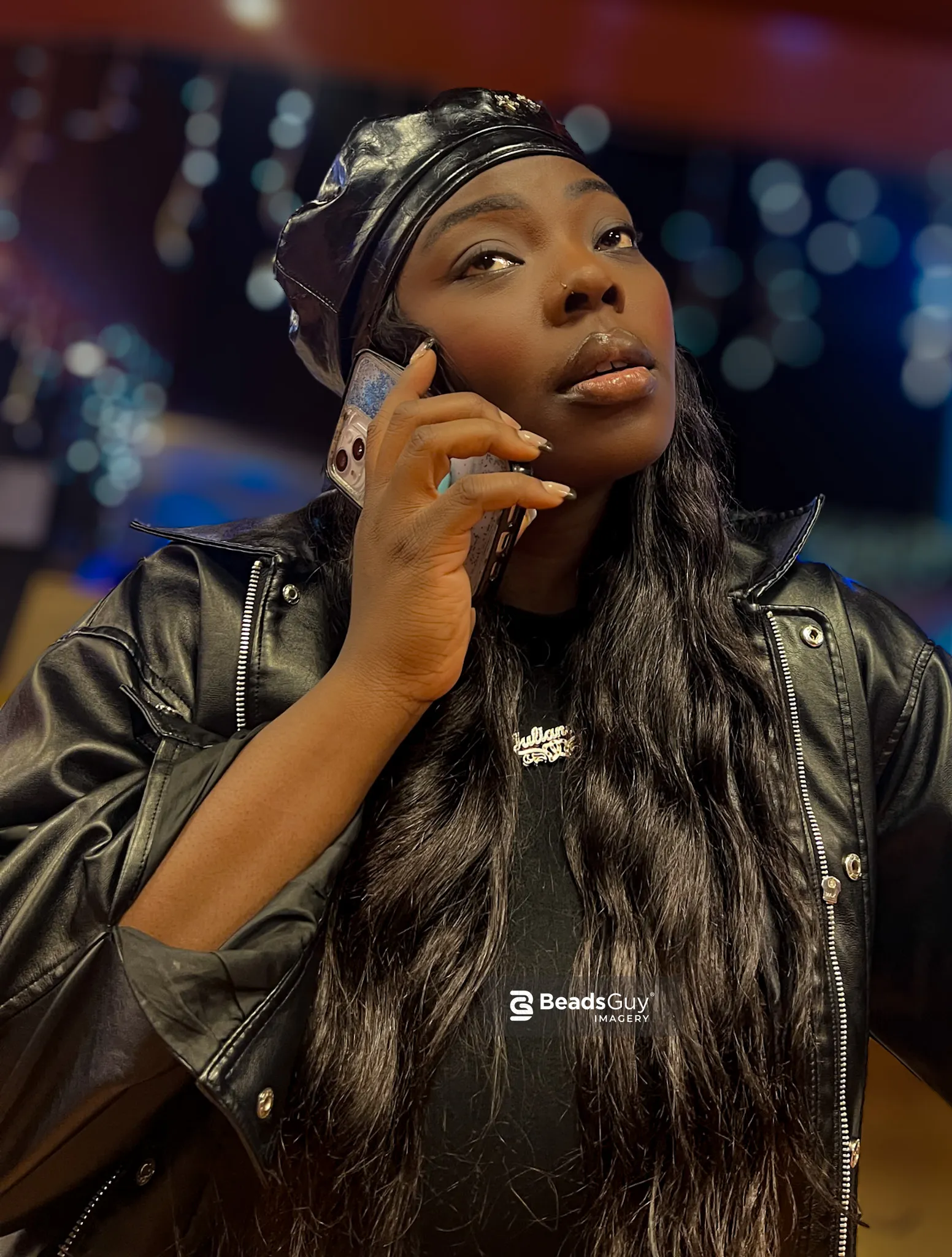 Woman in leather jacket on phone, bokeh background