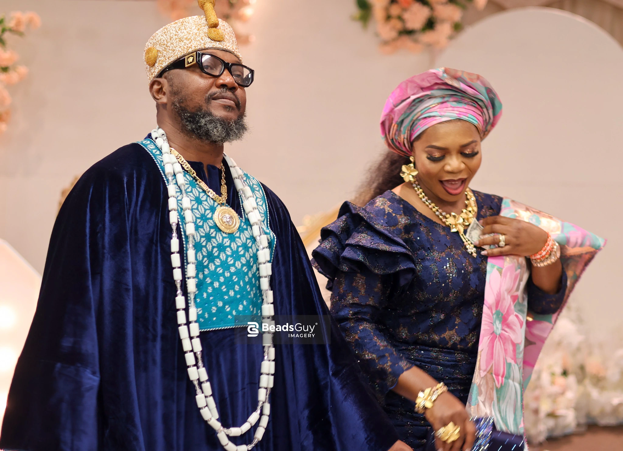 Nigerian traditional wedding couple in royal blue agbada and gele